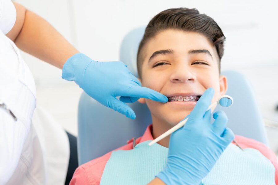 orthodontist looking at a child's braces