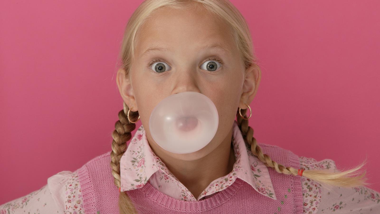 child with braces chewing gum