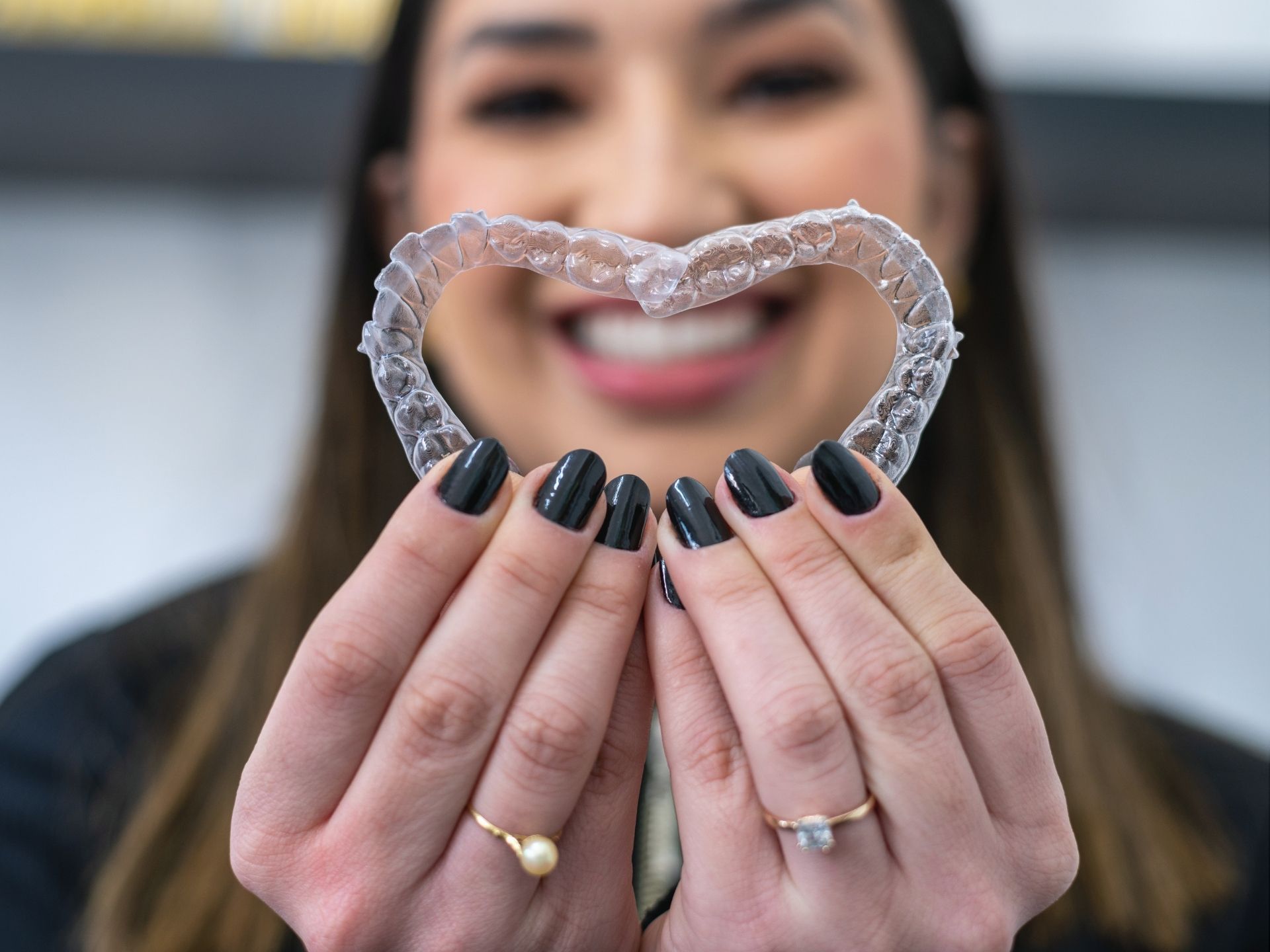 woman holding invisalign aligners together.